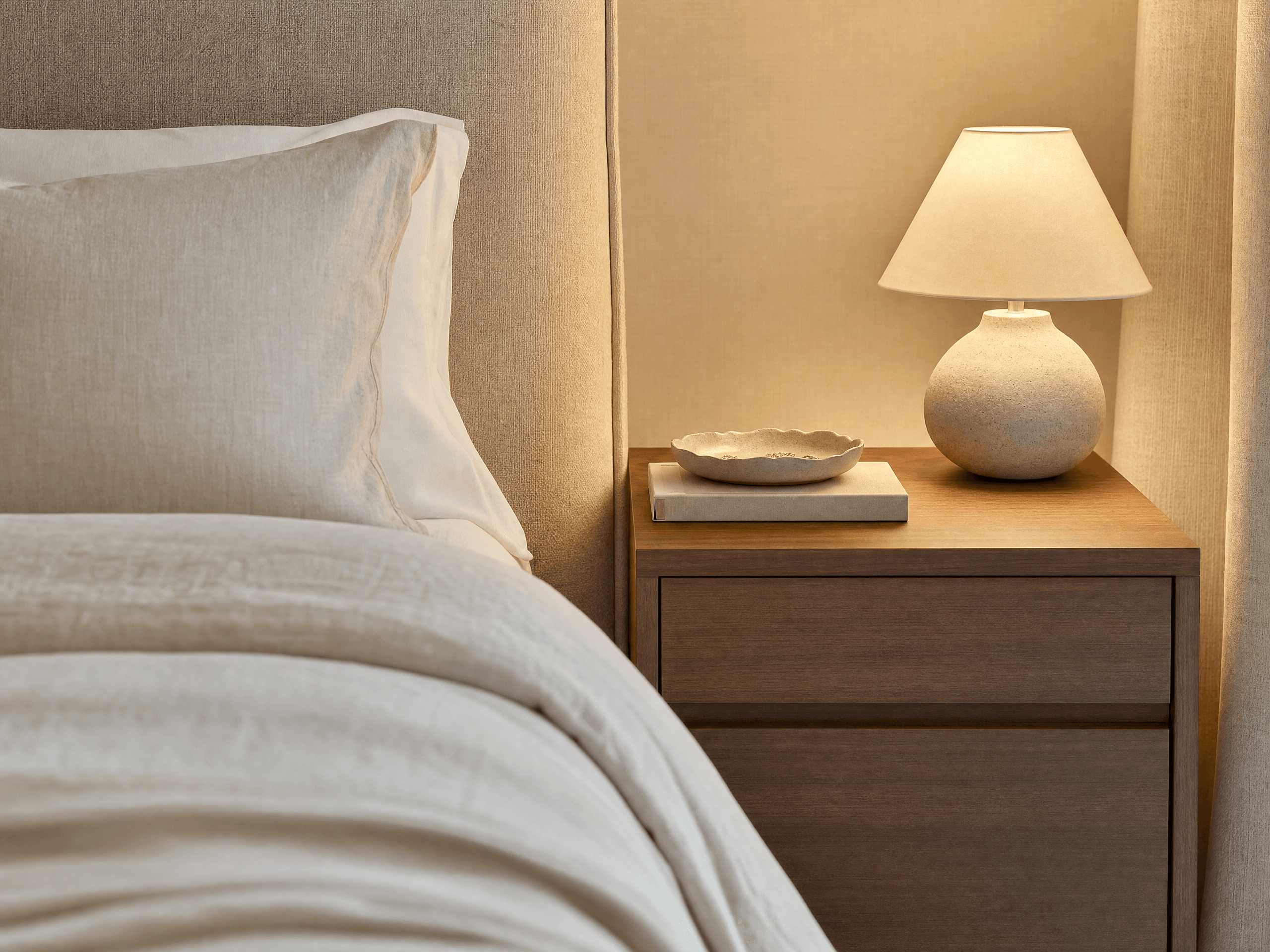 Close-up photorealistic elegant small bedroom bedside area with completely concealed charging cables